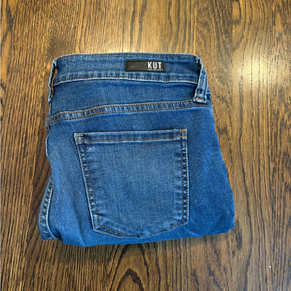 Sz 10 KUT medium wash denim. Very little distressing. Unfinished hem.